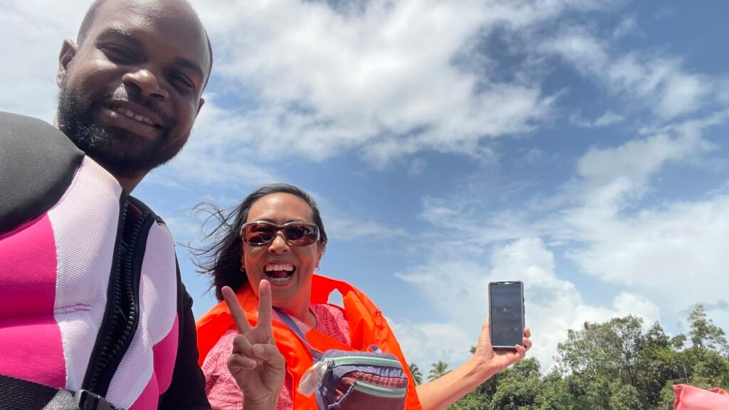 tourist showing victory sign in essequibo river tour